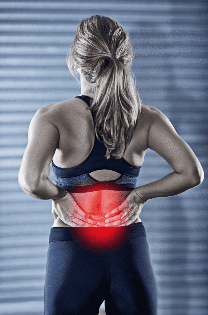 Woman experiencing lower back pain, holding her back with red highlight.