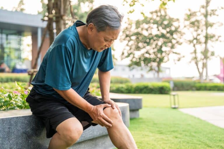 Man with pain in his knee resting